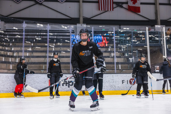 Woman trying hockey for the first time.