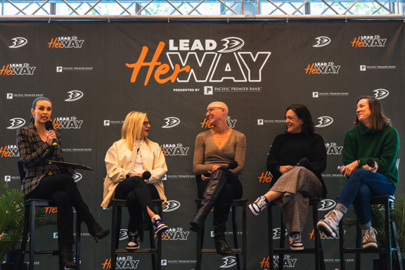 Women in Sports Lead Her Way panel laughing together.